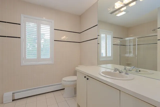 a bathroom with a sink toilet and a mirror