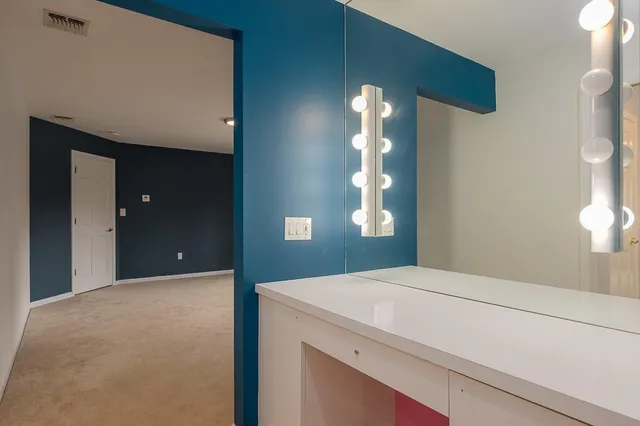 a bathroom with a sink and mirror