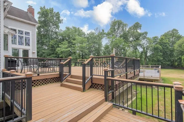 a view of a balcony with wooden floor and fence
