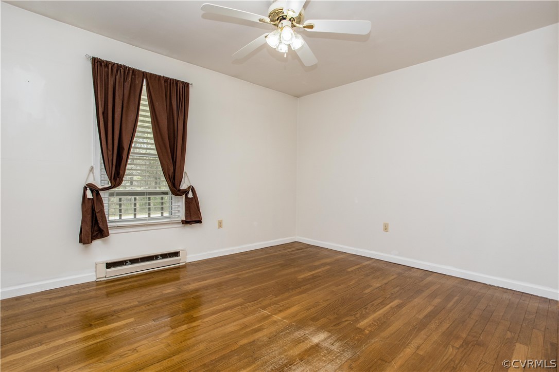 11610 Buckhorn Road Chesterfield, VA 23838 - Photo 15 of 37 a view of a livingroom with wooden floor and a ceiling fan