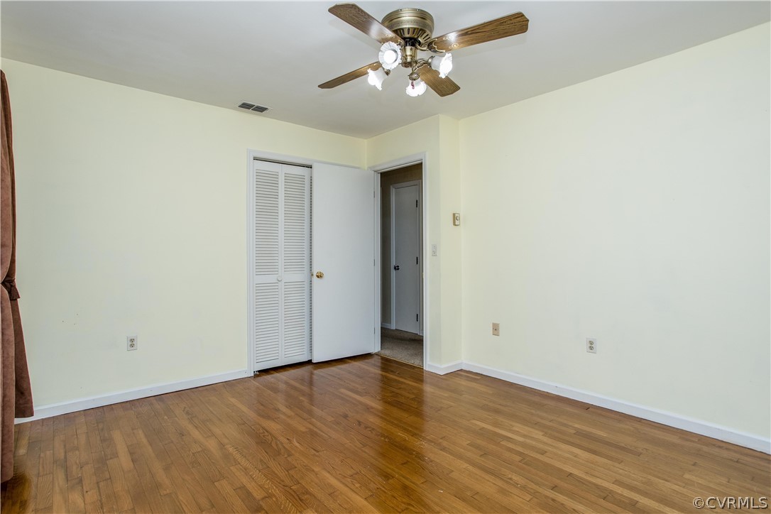 11610 Buckhorn Road Chesterfield, VA 23838 - Photo 18 of 37 an empty room with wooden floor and ceiling fan