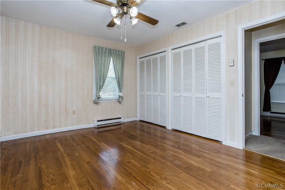11610 Buckhorn Road Chesterfield, VA 23838 - Photo 21 of 37 an empty room with wooden floor chandelier fan and windows