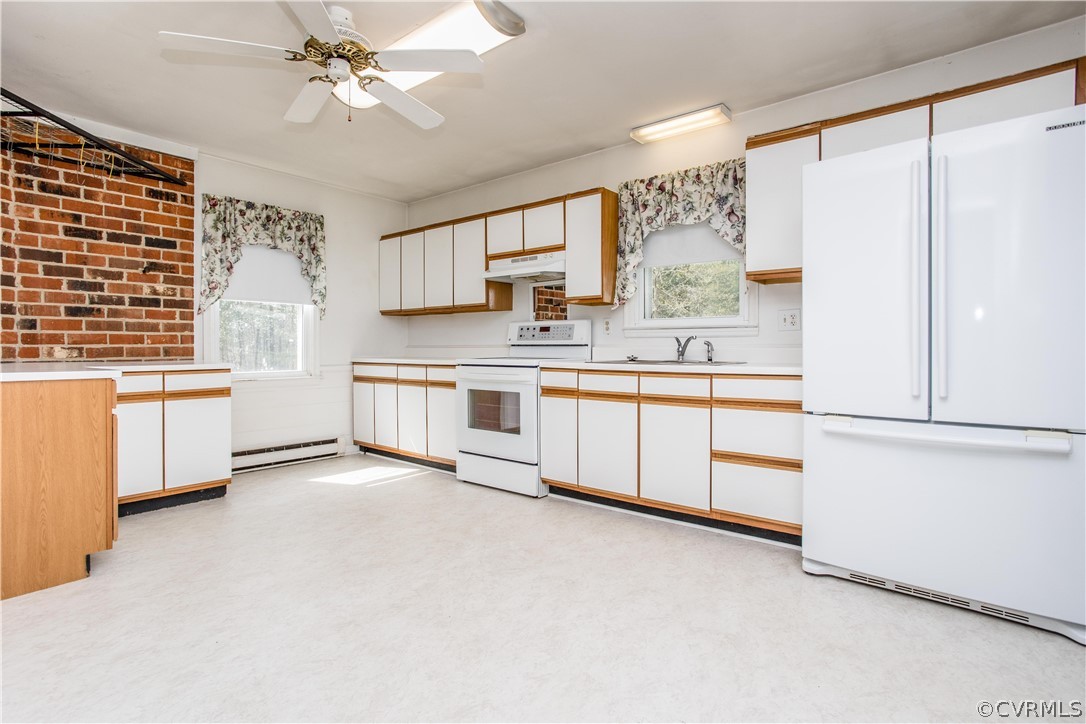 11610 Buckhorn Road Chesterfield, VA 23838 - Photo 6 of 37 a kitchen with stainless steel appliances a stove a sink and white cabinets