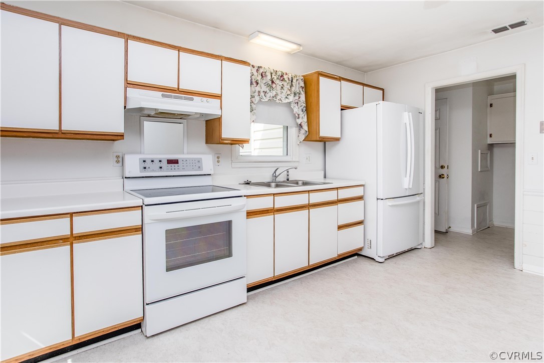 11610 Buckhorn Road Chesterfield, VA 23838 - Photo 10 of 37 a kitchen with white cabinets and white appliances