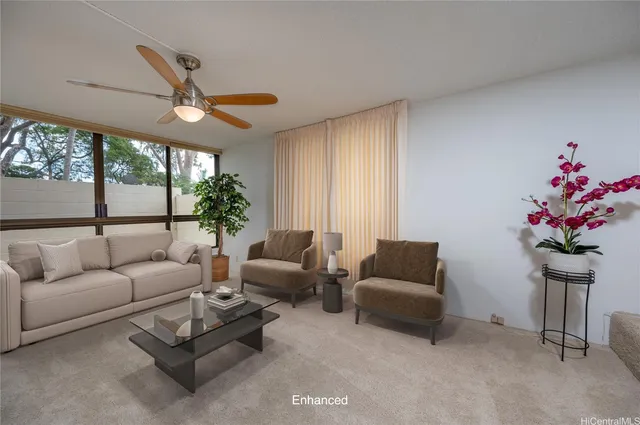 a living room with furniture flower and a large window