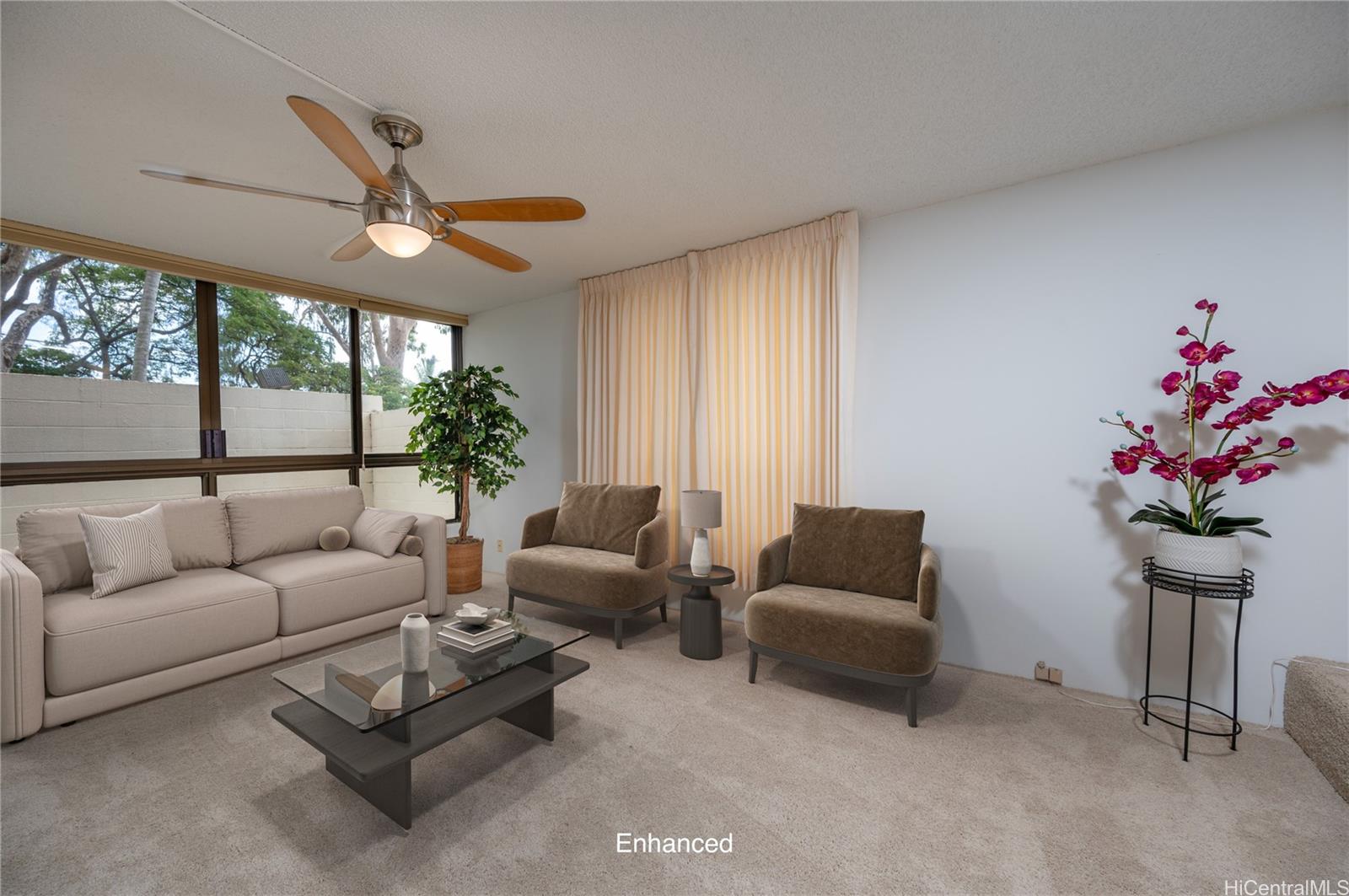 a living room with furniture flower and a large window