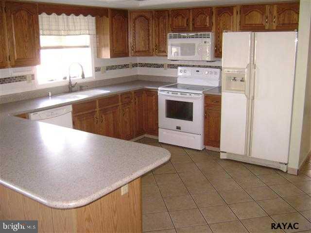 5200 Geeting Road Westminster, MD 21158 - Photo 3 of 6 a kitchen with a white cabinets and white appliances
