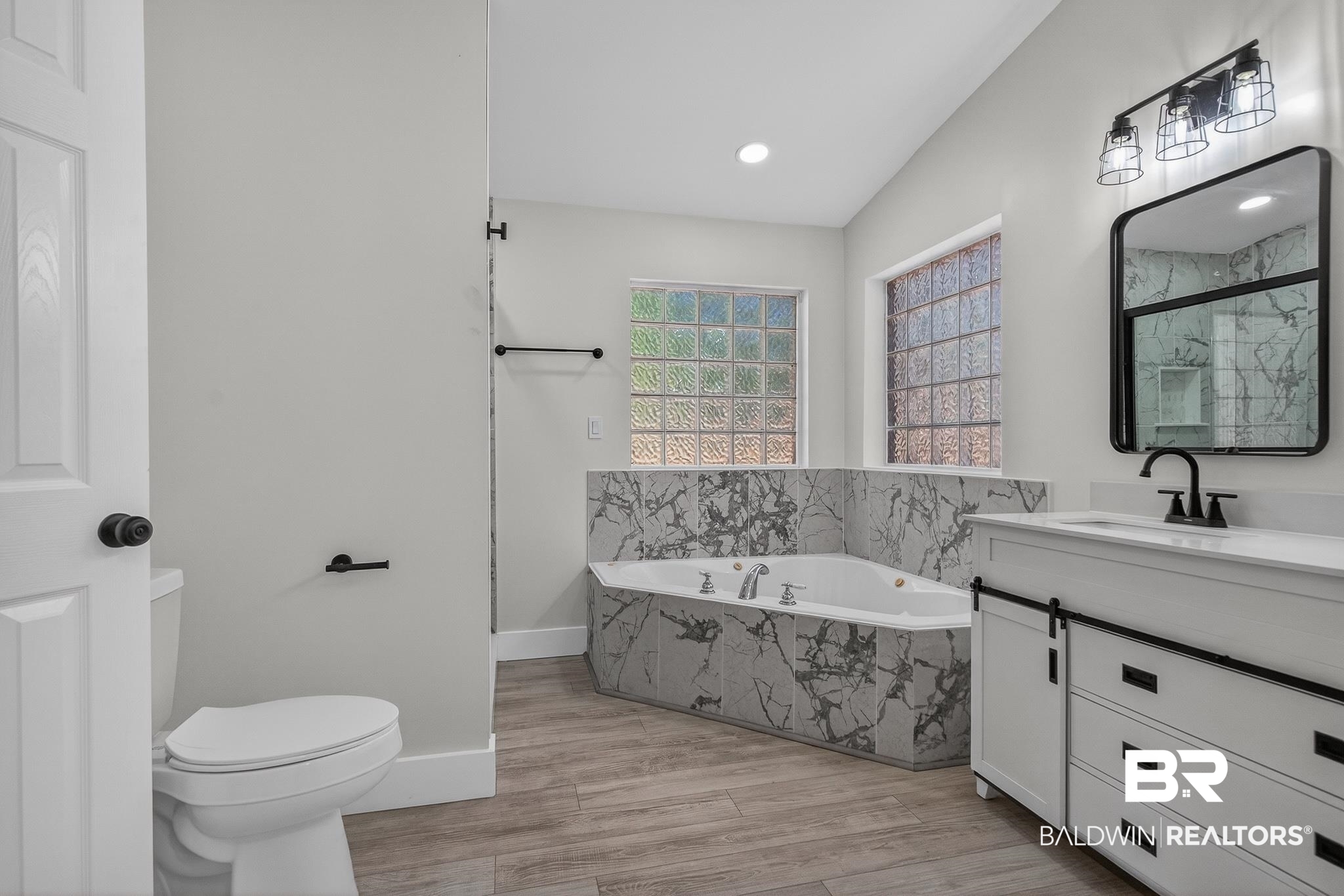 10650 Old Pascagoula Road Theodore, AL 36582 - Photo 66 of 77 Full bath featuring vanity, a bath, a marble finish shower, and light wood-type flooring
