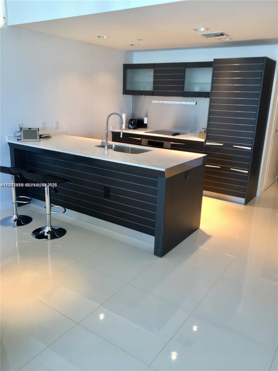 200 Biscayne Blvd Way, Unit 3712 Miami, FL 33131 - Photo 11 of 18 a kitchen with a stove and a sink