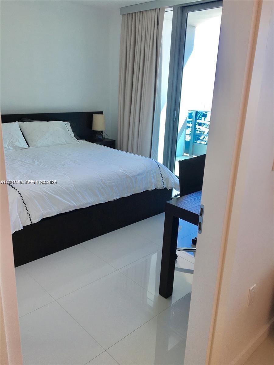 200 Biscayne Blvd Way, Unit 3712 Miami, FL 33131 - Photo 14 of 18 a bedroom with a bed and a window