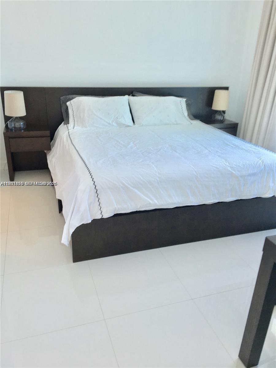 200 Biscayne Blvd Way, Unit 3712 Miami, FL 33131 - Photo 15 of 18 a bedroom with a bed and window