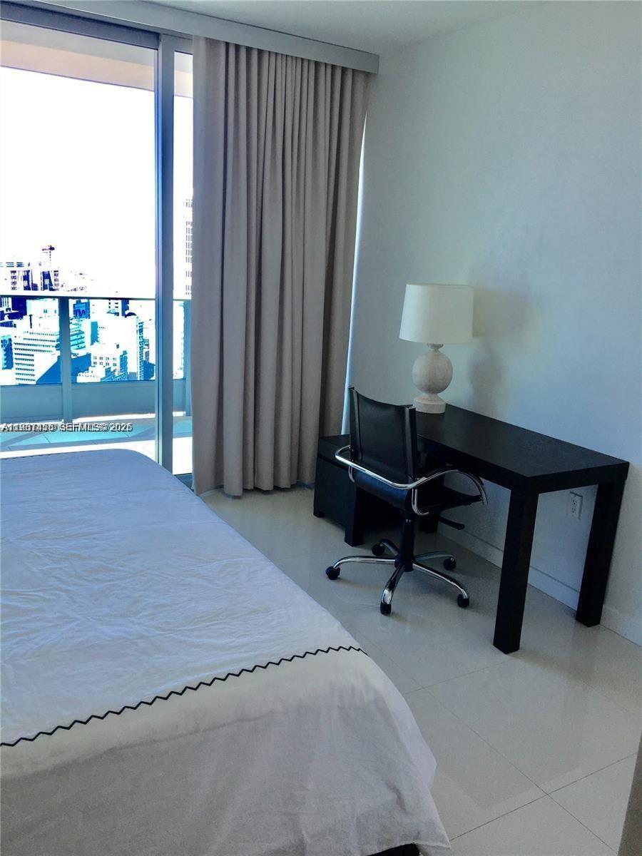 200 Biscayne Blvd Way, Unit 3712 Miami, FL 33131 - Photo 16 of 18 a bedroom with a bed and a window