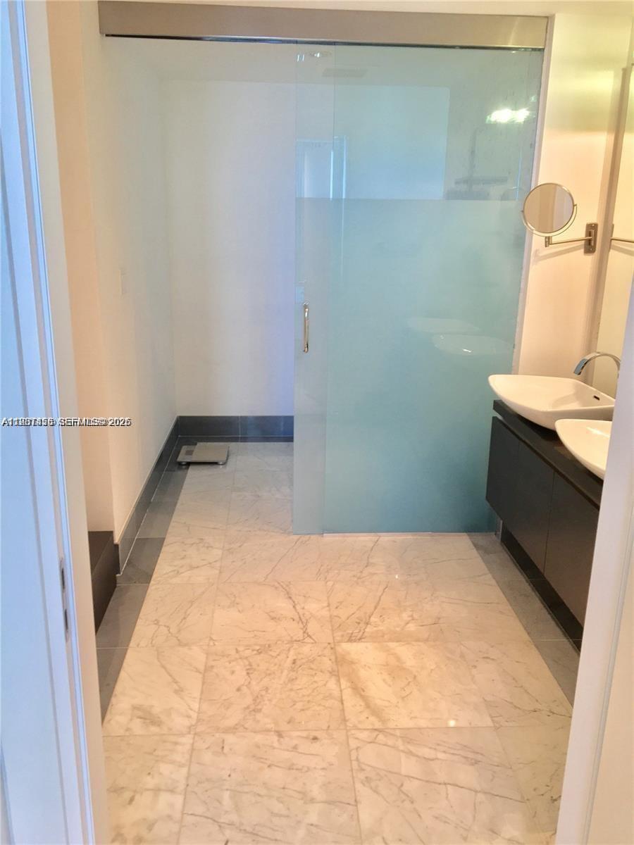 200 Biscayne Blvd Way, Unit 3712 Miami, FL 33131 - Photo 17 of 18 a bathroom with a sink and a shower
