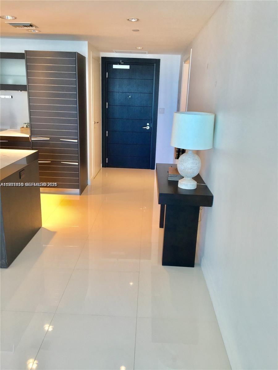 200 Biscayne Blvd Way, Unit 3712 Miami, FL 33131 - Photo 10 of 18 a view of a living room with a table and a lamp