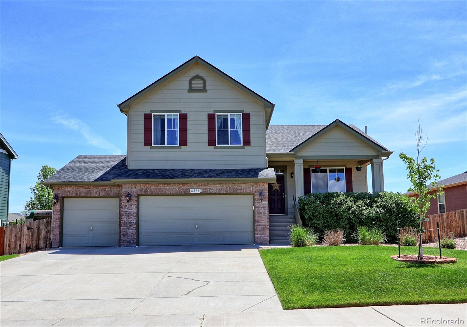 8376 Brandywine Avenue Frederick, CO 80504 - Photo 1 of 31 a front view of a house with a yard and garage