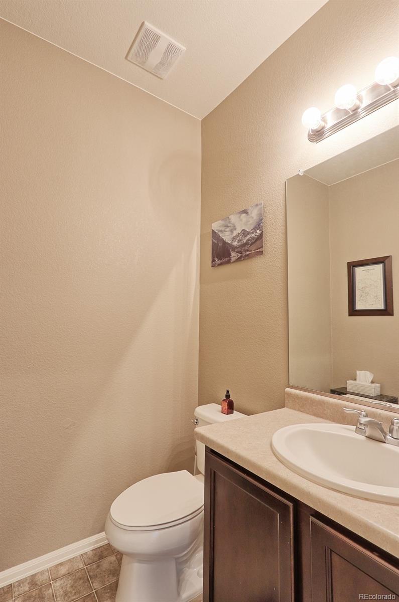 8376 Brandywine Avenue Frederick, CO 80504 - Photo 14 of 31 a bathroom with a granite countertop sink and a toilet