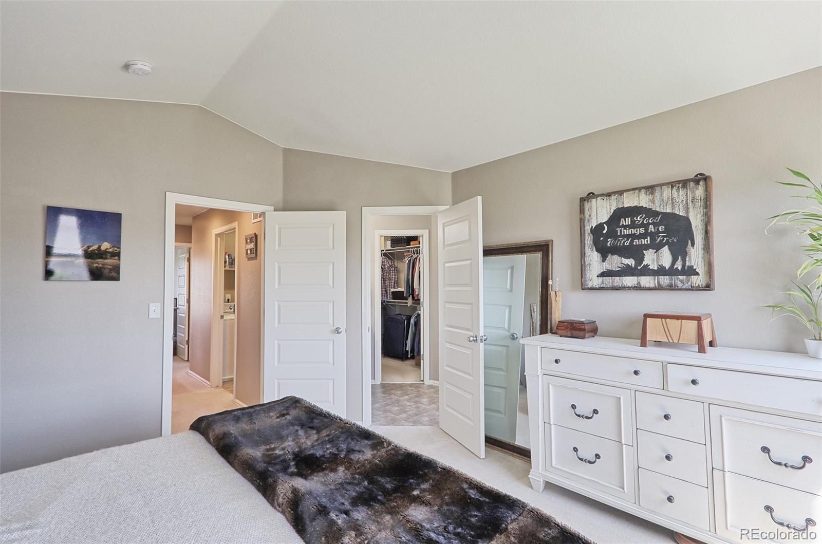 8376 Brandywine Avenue Frederick, CO 80504 - Photo 16 of 31 a bedroom with a bed and a dresser in it