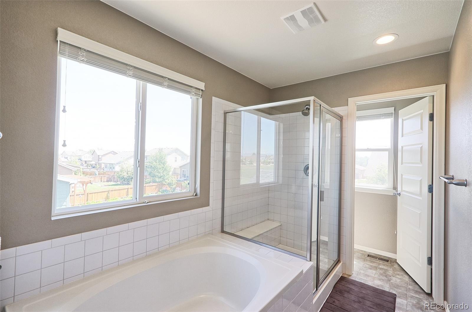 8376 Brandywine Avenue Frederick, CO 80504 - Photo 18 of 31 a bathroom with a bathtub and a shower