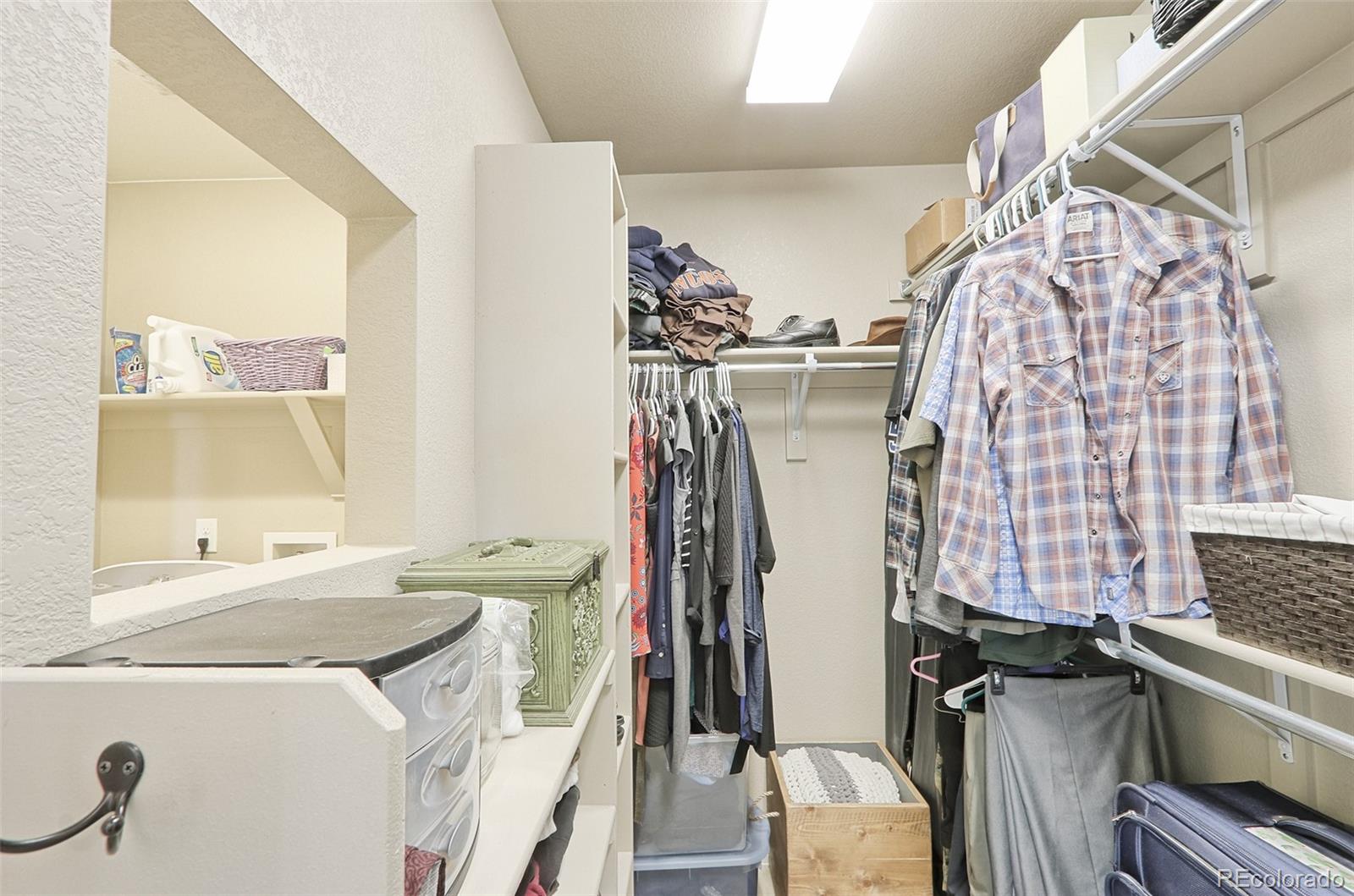 8376 Brandywine Avenue Frederick, CO 80504 - Photo 19 of 31 a view of walk in closet with clothes and shoes