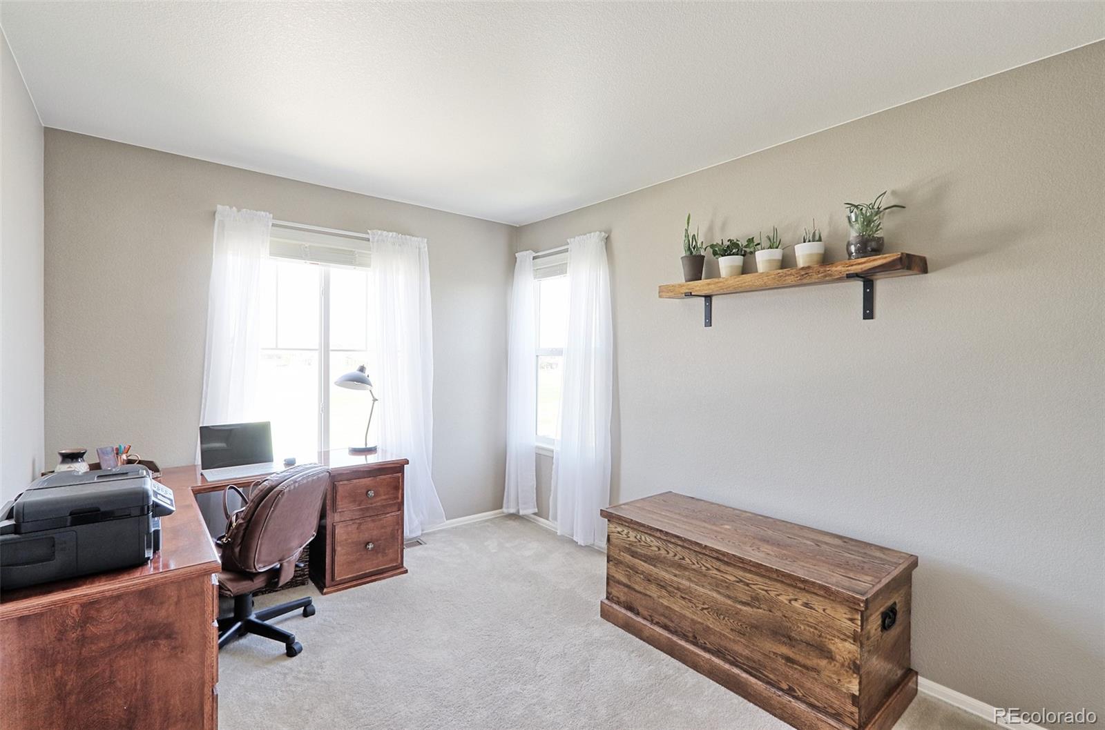 8376 Brandywine Avenue Frederick, CO 80504 - Photo 20 of 31 a view of a workspace with furniture and a window