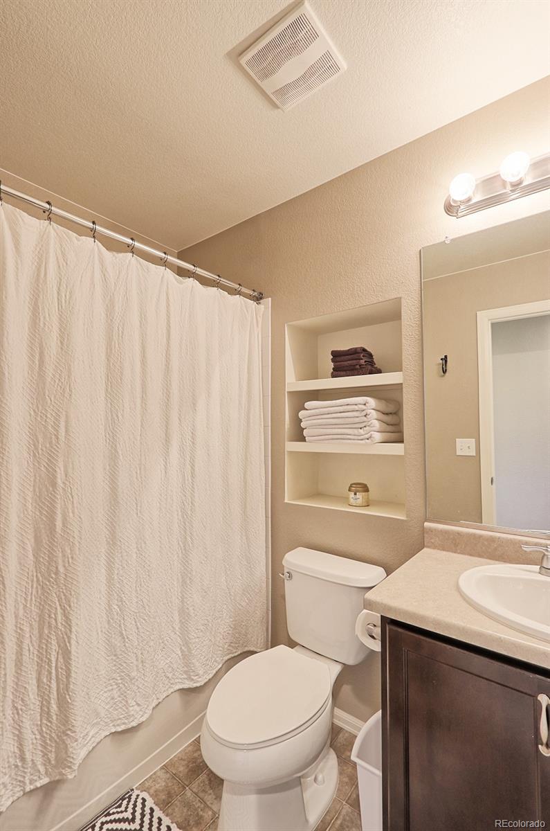 8376 Brandywine Avenue Frederick, CO 80504 - Photo 21 of 31 a bathroom with a toilet a sink and a shower