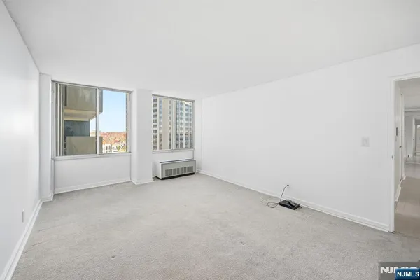 an empty room with entrance and windows