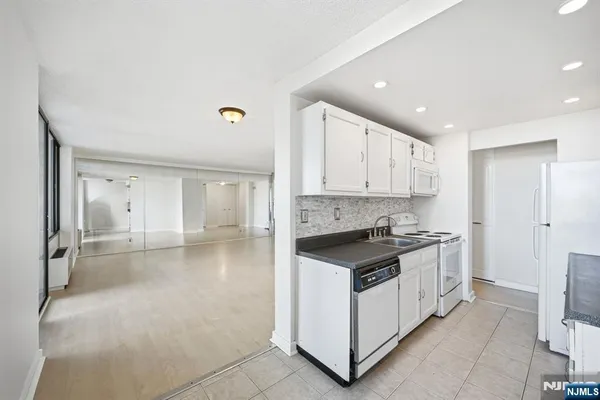 a kitchen with stainless steel appliances granite countertop a stove and a refrigerator