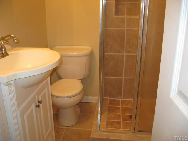 8524 Brogden Road Smithfield, NC 27577 - Photo 12 of 12 This new bath has a tile floor and tiled walls in the shower. Bathroom