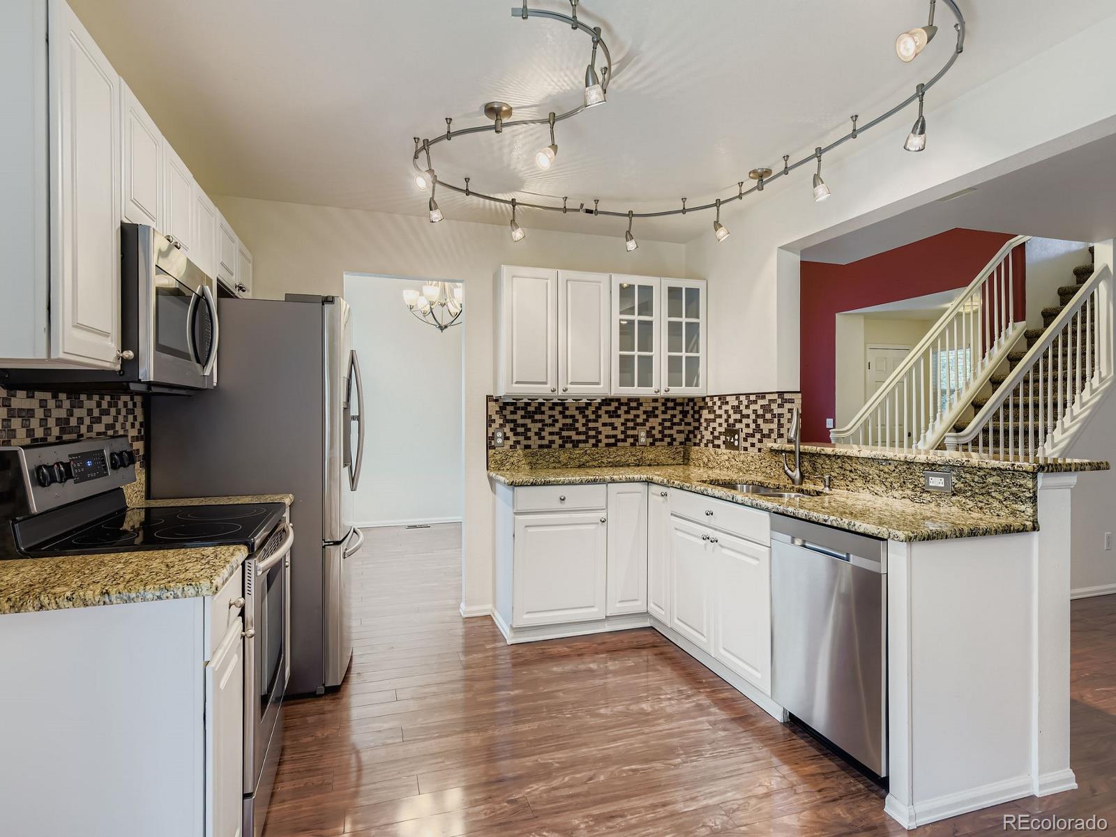 2266 West Ashwood Place Highlands Ranch, CO 80129 - Photo 13 of 48 a kitchen with granite countertop a sink and cabinets