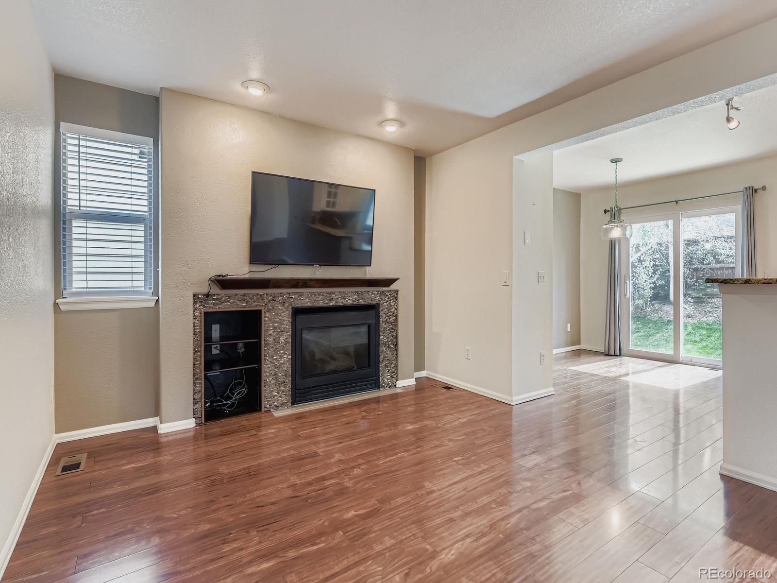 2266 West Ashwood Place Highlands Ranch, CO 80129 - Photo 17 of 48 a view of an empty room with a fireplace and a window