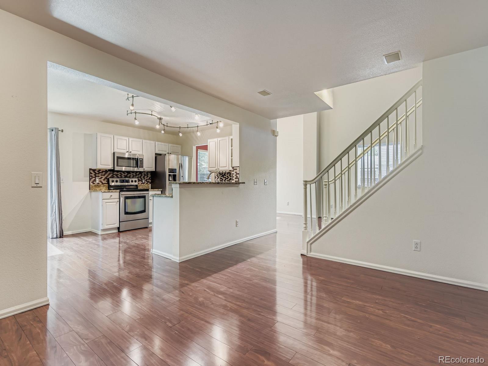 2266 West Ashwood Place Highlands Ranch, CO 80129 - Photo 18 of 48 a view of kitchen with wooden floor and electronic appliances
