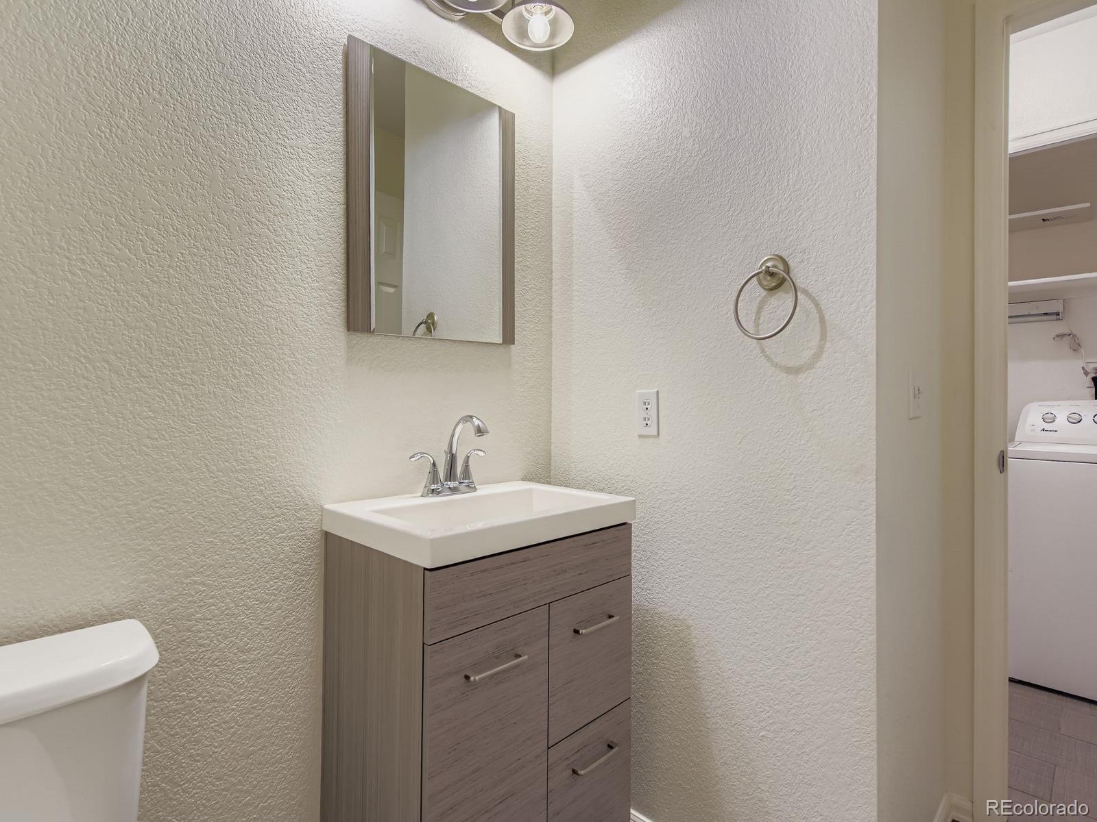 2266 West Ashwood Place Highlands Ranch, CO 80129 - Photo 19 of 48 a bathroom with a toilet sink vanity and mirror