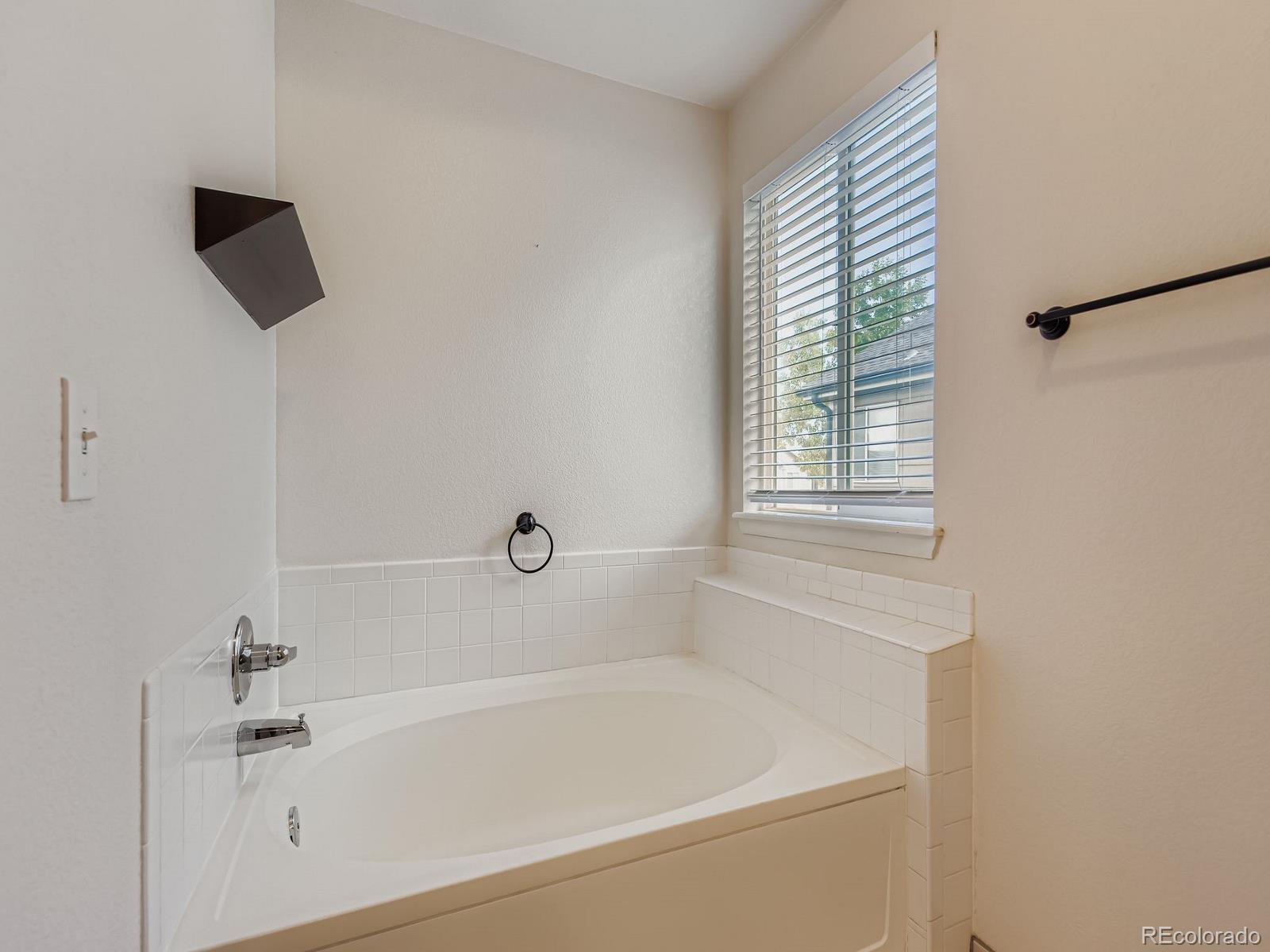2266 West Ashwood Place Highlands Ranch, CO 80129 - Photo 24 of 48 a white bath tub sitting next to a white sink
