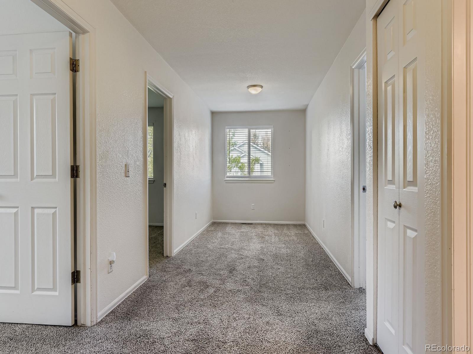 2266 West Ashwood Place Highlands Ranch, CO 80129 - Photo 29 of 48 an empty room with windows