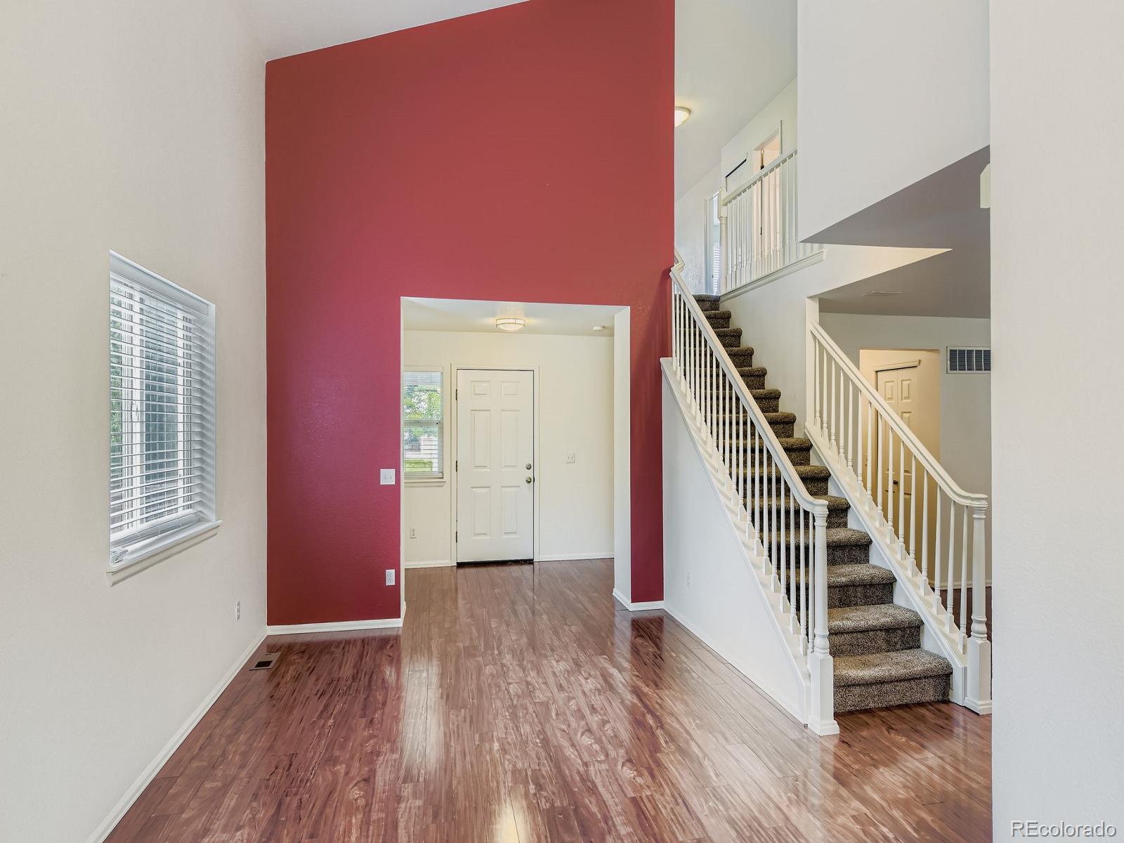 2266 West Ashwood Place Highlands Ranch, CO 80129 - Photo 7 of 48 a view of entryway and hall with wooden floor