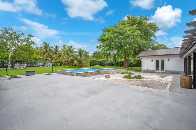 a view of a house with backyard and a play ground