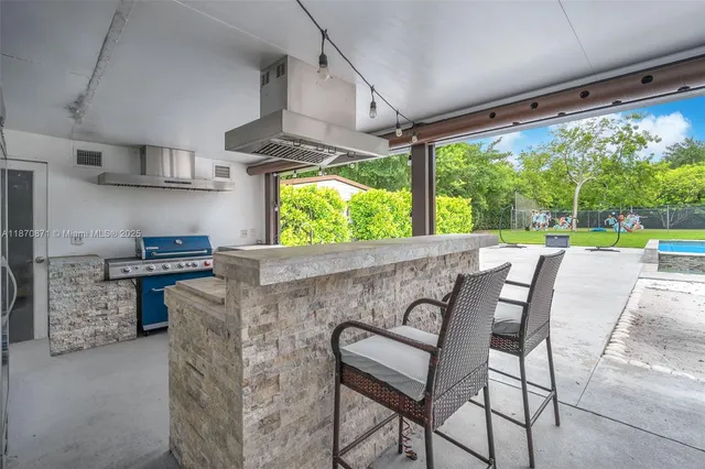 a kitchen with a table chairs stove and cabinets