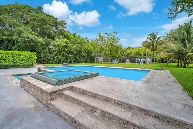 a view of a backyard with swimming pool