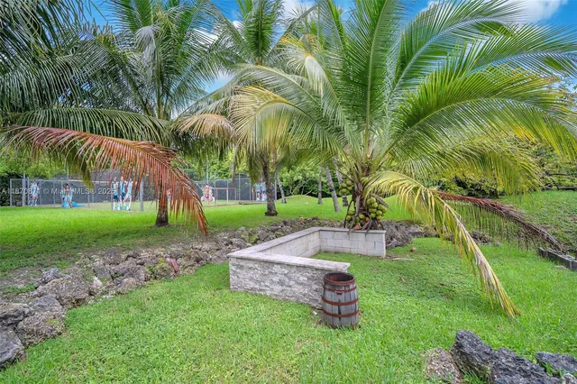 a view of a backyard with a garden and entertaining space