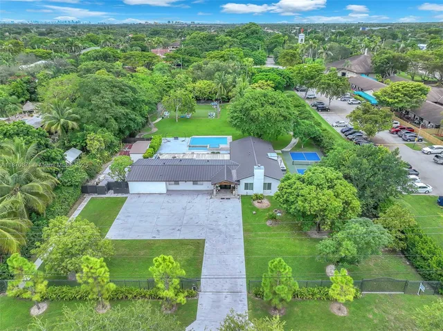 an aerial view of a house with yard