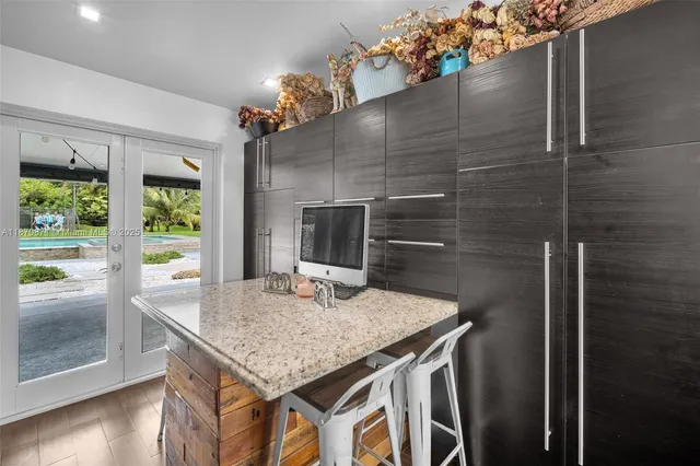 a dining table with chairs and potted plant