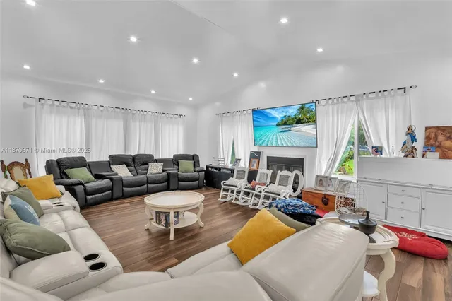 a living room with furniture fireplace and a flat screen tv