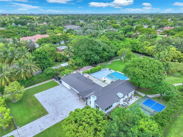 an aerial view of a house with a yard