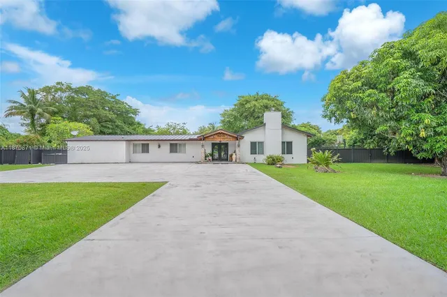 a view of house with a yard