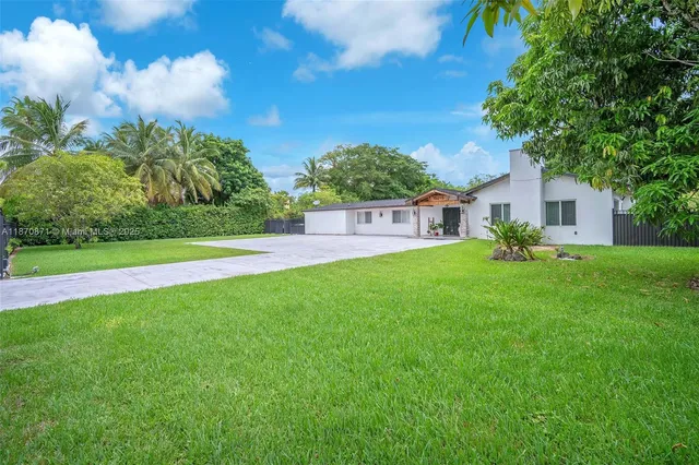 a view of a house with a backyard porch and sitting area