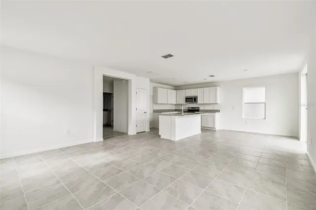 a view of kitchen with granite countertop cabinets and white appliances