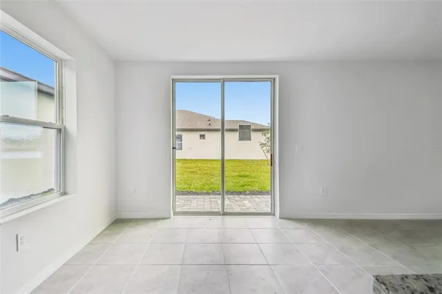 an empty room with a sliding door and a shower