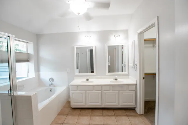 a spacious bathroom with a bathtub shower and sink