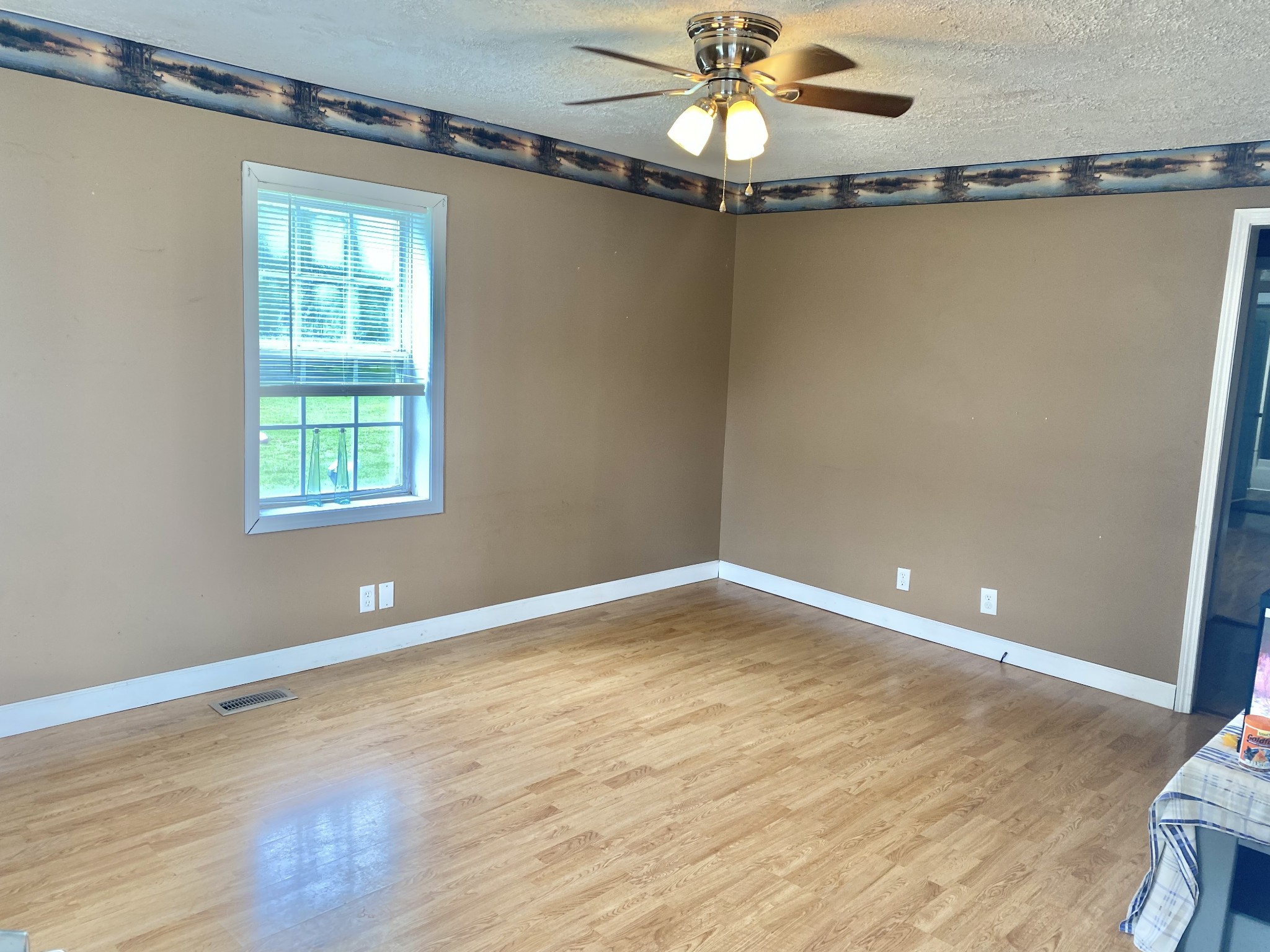 271 Hunt Street Manchester, TN 37355 - Photo 7 of 21 a view of an empty room with a window and wooden floor