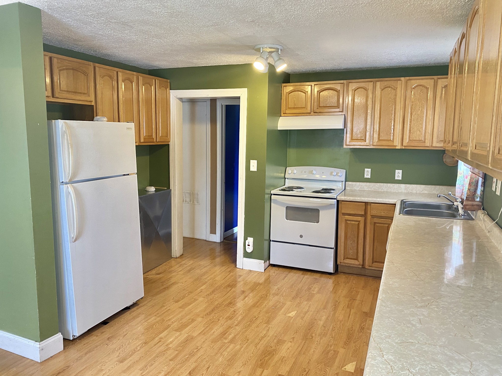 271 Hunt Street Manchester, TN 37355 - Photo 10 of 21 a kitchen with a refrigerator a stove top oven a refrigerator and cabinets
